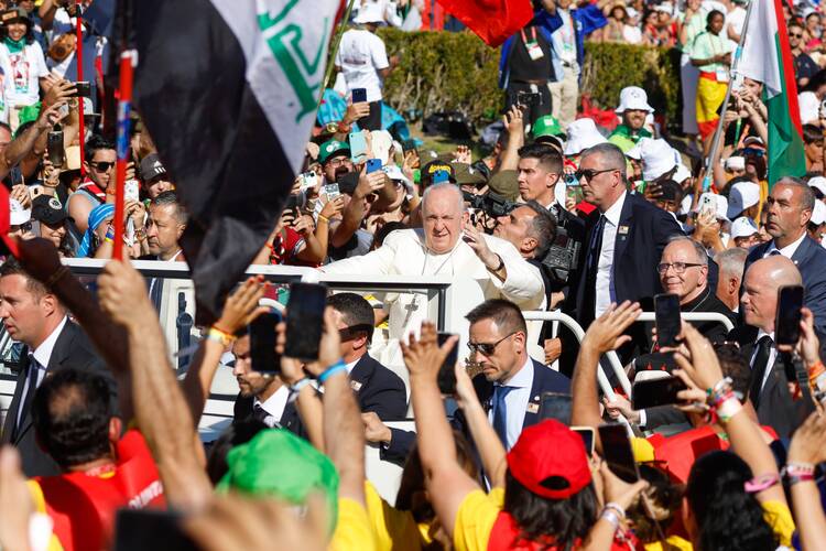 Young people cheer as Pope Francis arrives in the popemobile for the World Youth Day Stations of the Cross with young people at Eduardo VII Park in Lisbon, Portugal, Aug. 4, 2023.