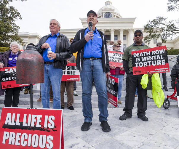 Former death row inmates who were exonerated, from left, Randall Padgent, Gary Drinkard and Ron Wright, were among the nearly 100 protestors gathered at the state capitol building in Montgomery, Ala., on Jan. 23, 2024, to ask Governor Kay Ivey to stop the planned execution of Kenneth Eugene Smith. (Mickey Welsh/The Montgomery Advertiser via AP)