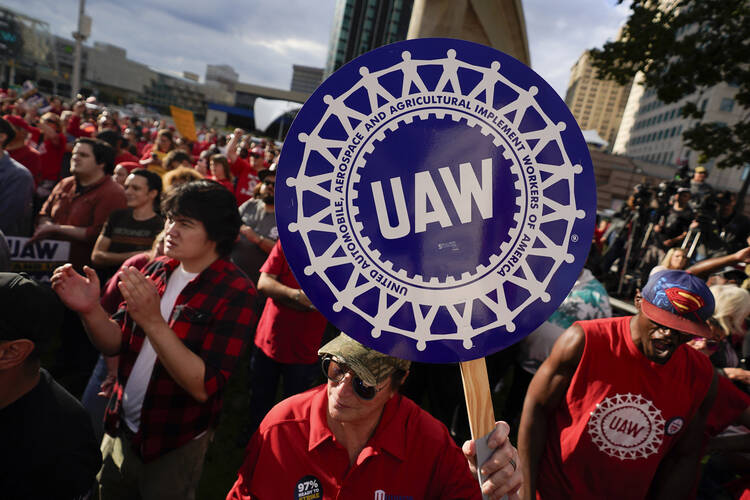 A trend toward goods and components made by unionized American workers may mean higher prices for consumers. In photo: United Auto Workers members attend a rally in Detroit on Sept. 15, 2023. (AP Photo/Paul Sancya, File)