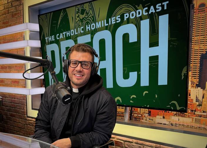 Father Rob Galea recording “Preach: The Catholic Homilies Podcast” inside the William J. Loschert Studio at America Media in New York City, February 2024