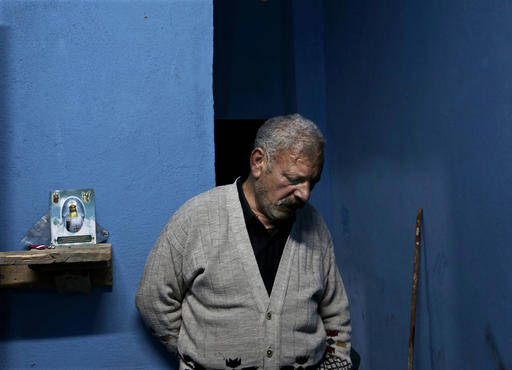 Egyptian Christian Ezzat Yaacoub Ishak, who fled el-Arish in North Sinai with his family two days ago due to fighting, stands in his newly rented apartment, in Ismailia, 120 kilometers (75 miles) east of Cairo, Egypt, on Sunday, Feb. 26, 2017. (AP Photo/Nariman El-Mofty)
