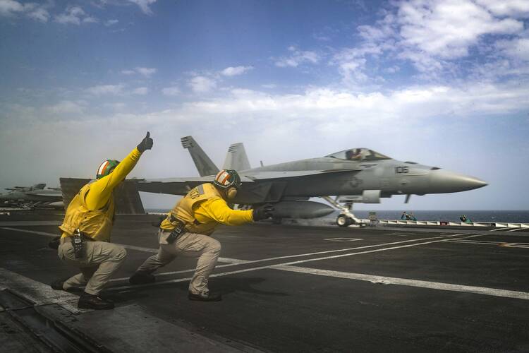 ARABIAN SEA (May 16, 2019) Lt. Nicholas Miller, from Spring, Texas, and Lt. Sean Ryan, from Gautier, Miss., launch an F/A-18E Super Hornet from the "Pukin' Dogs" of Strike Fighter Squadron (VFA) 143 on the flight deck of the Nimitz-class aircraft carrier USS Abraham Lincoln (CVN 72). (U.S. Navy photo by Mass Communication Specialist 3rd Class Jeff Sherman/Released)