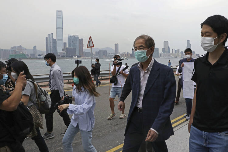 Former pro-democracy lawmaker Martin Lee leaves a police station in Hong Kong on April 18. Hong Kong police arrested at least 14 pro-democracy lawmakers and activists on charges of joining unlawful protests last year calling for reforms. (AP Photo/Kin Cheung)