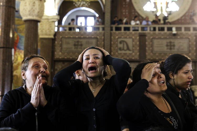 Mourning during the funeral for those killed in a Palm Sunday church attack in Alexandria Egypt, at the Mar Amina church, Monday, April 10, 2017. (AP Photo/Samer Abdallah)