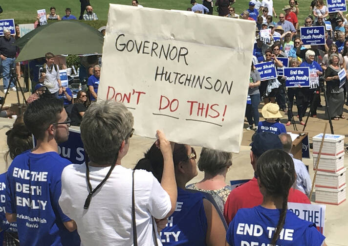 Protesters gather outside the state Capitol building on Friday, April 14, 2017, in Little Rock, Ark., to voice their opposition to Arkansas' seven upcoming executions. (AP Photo/Kelly P. Kissel)