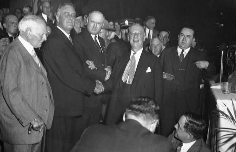 After a fierce battle for the presidential nomination in June 1932, Al Smith shakes hands with Gov. Franklin D. Roosevelt at the state Democratic convention in Albany, N.Y., Oct. 4, 1932. (AP photo)