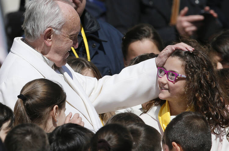  04.19.2017 Pope Francis greets a young choir member during his general audience in St. Peter's Square at the Vatican April 19. (CNS photo/Paul Haring)