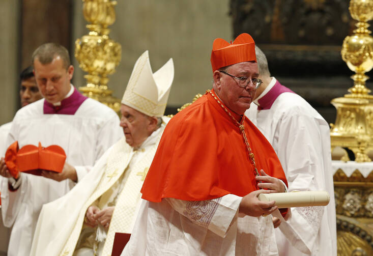 New Cardinal Jean-Claude Hollerich of Luxembourg carries his scroll after being made a cardinal by Pope Francis during a consistory in St. Peter's Basilica at the Vatican Oct. 5, 2019. (CNS photo/Paul Haring)