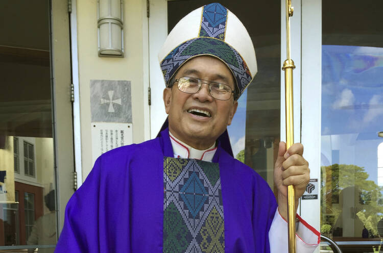 In this November, 2014 file photo, Archbishop Anthony Apuron stands in front of the Dulce Nombre de Maria Cathedral Basilica in Hagatna, Guam. (AP Photo/Grace Garces Bordallo, File)