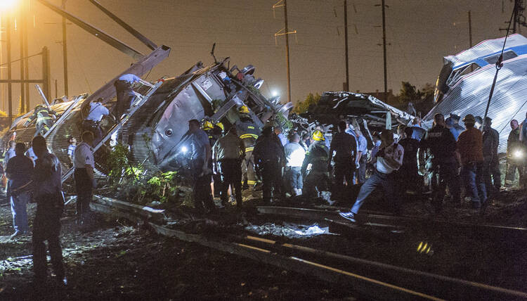 Rescue workers search for victims in wreckage of derailed Amtrak train in Philadelphia, May 12 (CNS photo/Bryan Woolston, Reuters).
