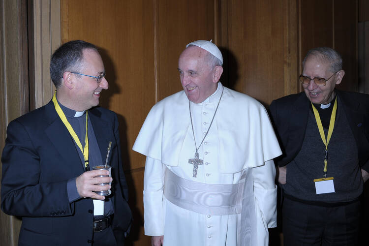 Pope Francis is pictured with Jesuit Father Antonio Spadaro, editor of La Civilta Cattolica, left, and Father Adolfo Nicolas, superior general of the Society of Jesus, during a break at a meeting with the superiors of men's religious orders at the Vatica n Nov. 29. During the meeting, the pope ordered the revision of norms on the relations between religious orders and local bishops. (CNS photo/L'Osservatore Romano) (Jan. 3, 2014)