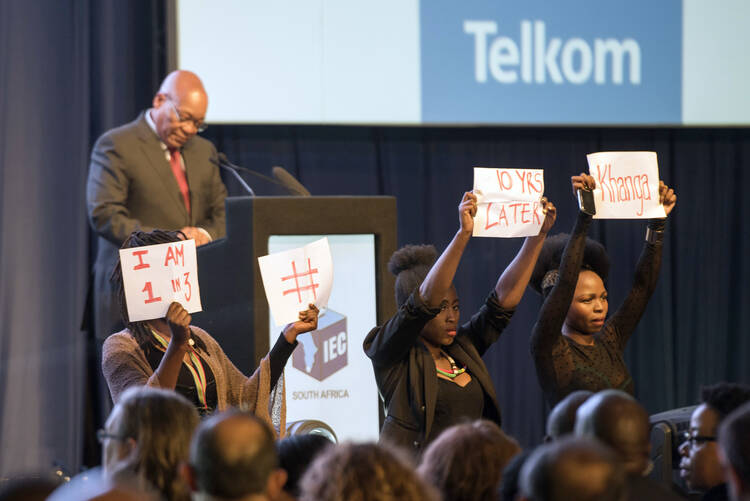 Protesters interrupt South Africa's President Jacob Zuma, as he delivers a speech at the announcement of the results of the municipal elections in Pretoria, South Africa on Aug. 6, 2016. (AP Photo/Herman Verwey)