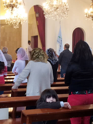 Assyrian Christians attend a service at St. Georges Assyrian Church of the East in Beirut, March 11 (CNS photo/Doreen Abi Raad). 