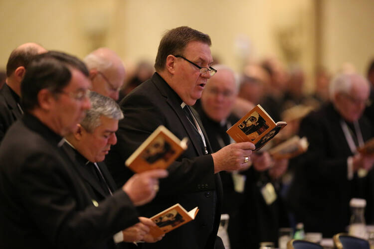 Cardinal-designate Joseph W. Tobin of Indianapolis, center, joins other bishops during morning prayer Nov. 15 at the annual fall general assembly of the U.S. Conference of Catholic Bishops in Baltimore (CNS photo/Bob Roller). 