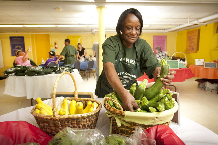 Betty Howard arranges produce at the City Greens at Midtown Center in St. Louis, June 17, 2010. The project is sponsored by Catholic Charities (CNS photo/Lisa Johnston, St. Louis Review).