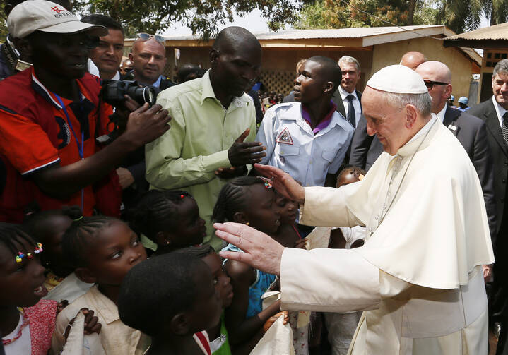 Pope Francis greets children as he visits a refugee camp in Bangui, Central African Republic, Nov. 29 (CNS photo/Paul Haring). 