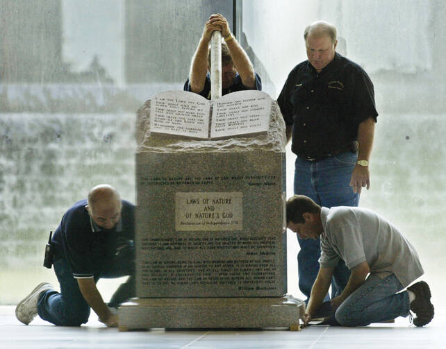 GOD-LESS: Workers remove a Ten Commandments monument from the Alabama Judicial Building in Montgomery in 2003.
