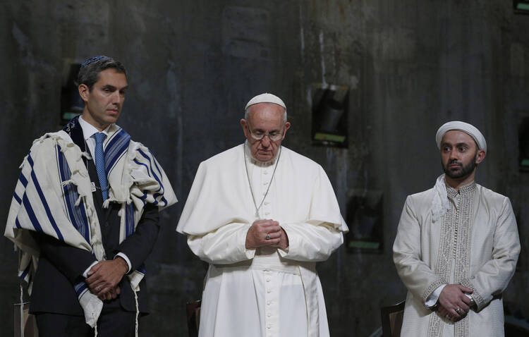 Pope Francis stands between Jewish and Muslim religious leaders during a prayer service at the ground zero 9/11 Memorial Museum in New York, Sept. 25 (CNS Photo / Paul Haring)..