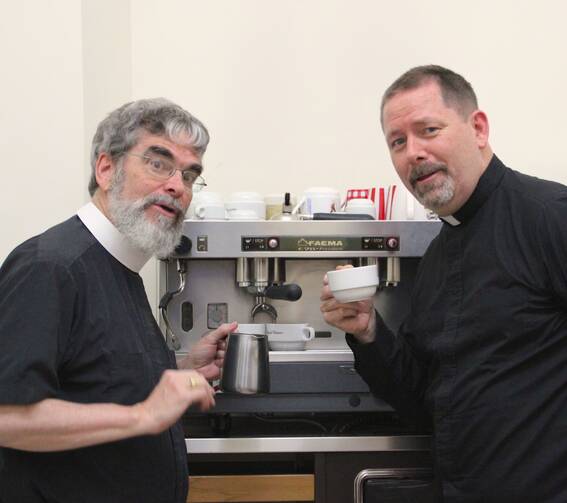 Brother Guy Consolmagno, S.J., and Father Paul Mueller, S.J. at the Vatican Observatory coffee machine. (photo provided)
