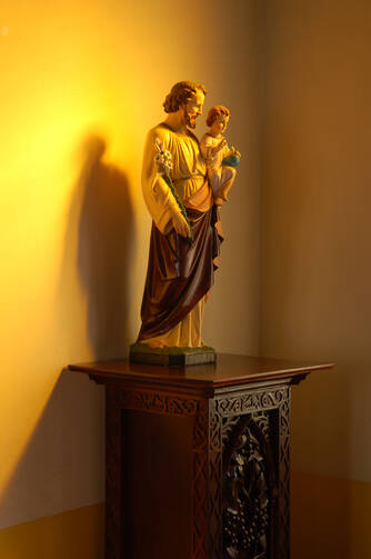 Saint Joseph, tenderly holding the Child Jesus near his heart