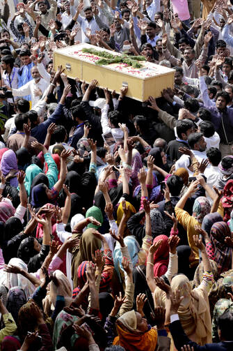 Pakistani Christians carry a coffin of a church bombing victim in Lahore, Pakistan, March 17. 