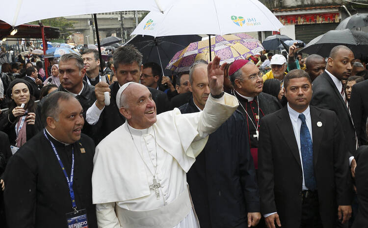 Pope Francis waves to residents in Varginha slum in Rio de Janeiro, July 25 (CNS/Paul Haring)
