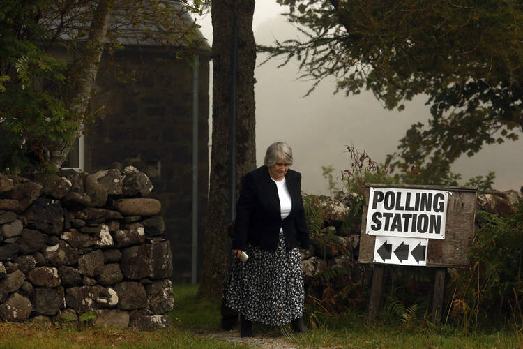  voter leaves a polling station in Portree, Scotland, Sept. 18. (CNS photo/Cathal McNaughton, Reuters)