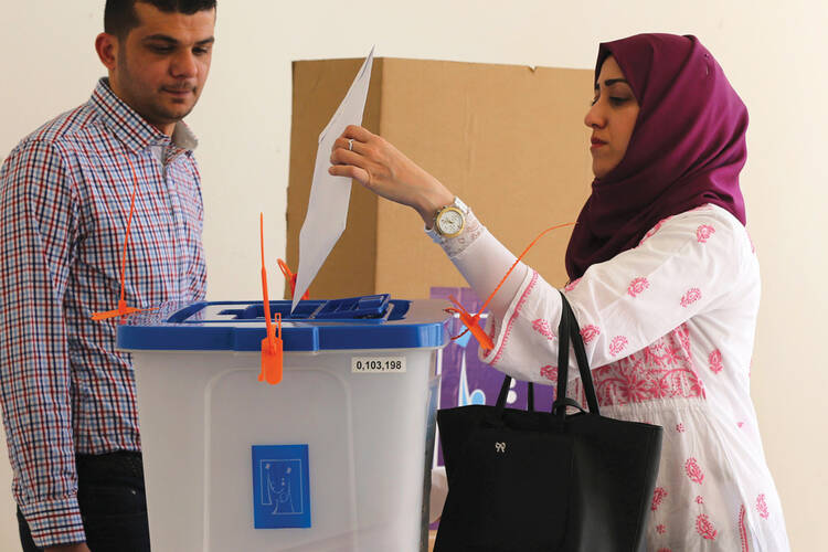 An Iraqi woman living in Jordan casts a ballot at a polling station in Amman.