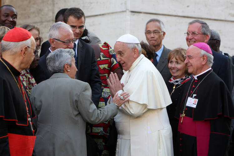 Pope Francis greets auditors of extraordinary Synod of Bishops on family as he arrives for afternoon session at Vatican, Oct. 10