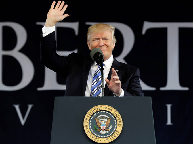 President Donald Trump waves before delivering keynote address at Liberty University's commencement in Lynchburg, Virginia, U.S., on May 13, 2017. Photo courtesy REUTERS/Yuri Gripas