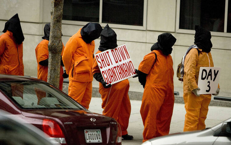 Protesters against the Guantanamo Bay prison line up outside the transition office of U.S. President-elect Barack Obama in 2009.
