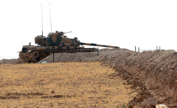 A Turkish tank is stationed near the Syrian border, in Karkamis, Turkey, Monday, Aug. 29, 2016. (Ismail Coskun/IHA via AP)