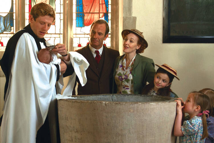 A MAN OF MANY TALENTS. Sidney Chambers baptizes the son of his crime-solving partner, Inspector Geordie Keating, in “Grantchester.”
