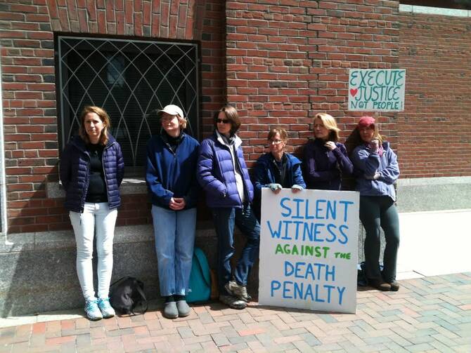 Death penalty opponents stood in front of the U.S. District Court in Boston on Monday.