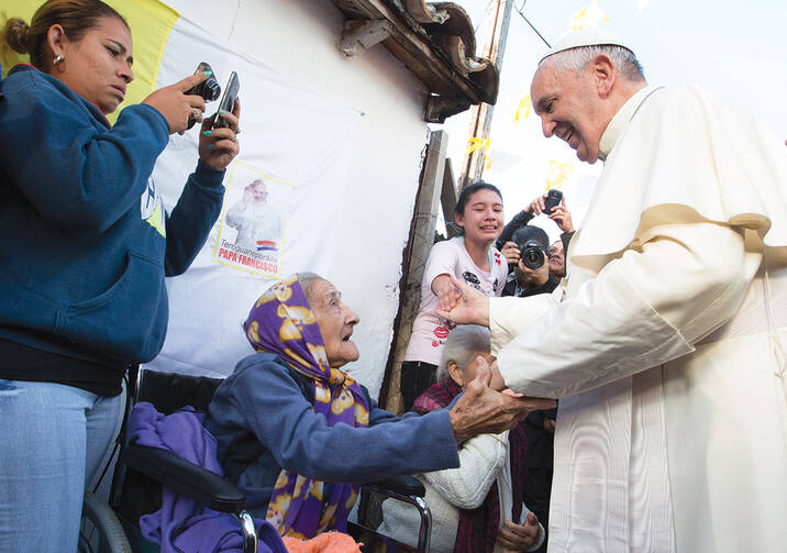 HUMANE TOUCH. Pope Francis with people of Banado Norte, a poor neighborhood in Asuncion, Paraguay, July 12. 