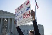 A supporter for same-sex marriage stands outside the U.S. Supreme Court in Washington April 28. The high court began hearing cases for same-sex marriages in states that bar the union. (CNS photo/Tyler Orsburn) 