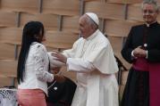 Pope Francis greets a young woman who gave a testimonial during a meeting with representatives of schools and universities at the Pontifical Catholic University of Ecuador in Quito July 7. (CNS photo/Paul Haring)