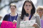 Attorney Isabel Saavedra speaks during a rally in front of the White House in Washington March 28 calling for an end to the detention of immigrant families who are seeking asylum. (CNS photo/Tyler Orsburn)