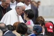 Pope Francis greets a young woman as he meets the disabled during his general audience in St. Peter's Square at the Vatican June 1. (CNS photo/Paul Haring)