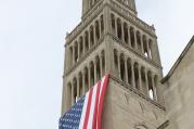 A large American flag is seen hanging from the bell tower of the Basilica of the National Shrine of the Immaculate Conception in Washington July 4, 2015. The U.S. bishops' fifth annual Fortnight for Freedom opens June 21. (CNS photo/Bob Roller)
