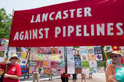 Activists with the Lancaster Against Pipelines carry a banner in late April during the People's Climate March in Washington. Nearly two dozen people were arrested Oct. 16 as they blocked workers from starting construction of a short leg of a natural gas pipeline on property owned by the Adorers of the Blood of Christ in Columbia, Pa. (CNS photo/Mark Dixon, Wikimedia Commons)