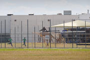 Children play in a double-fenced playground area outside the T. Don Hutto "Family Residential Facility" in Taylor, Texas. Migration is not a crime and vulnerable migrant and refugee children should not be detained as if they were criminals, speakers said at a U.N. program Feb 21 in New York City. (CNS photo/Bahram Mark Sobhani)