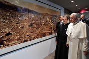 Pope Francis walks by a photo showing the destruction of an atomic bomb during a visit to the Jesuit-run Sophia University in Tokyo on Nov. 26, 2019. (CNS photo/Vatican Media via Reuters)