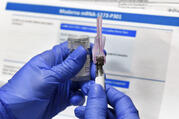 A nurse prepares a shot as a study of a possible Covid-19 vaccine, developed by the National Institutes of Health and Moderna Inc., on July 27 in Binghamton, N.Y. (AP Photo/Hans Pennink)
