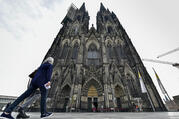 In this Sunday, May 3, 2020 file photo people arrive for a church service at Germany's famous Cologne Cathedral in Cologne, Germany. (AP Photo/Martin Meissner, file)