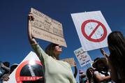 Anti-vaccine protestors hold placards during a march against COVID-19 vaccinations in Cape Town, South Africa