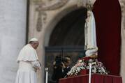 Pope Francis prays in front of the original statue of Our Lady of Fatima during a Marian vigil in St. Peter's Square at the Vatican.
