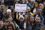 A woman holds a sign reading “Women for Deacons” as Pope Francis leads his general audience in St. Peter's Square at the Vatican Nov. 6, 2019.