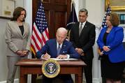 President Joe Biden signs an executive order at the White House in Washington July 8, 2022, that he said would help safeguard women's access to abortion and contraceptives. He stated the order was a necessary response to the Supreme Court's June 24 decision overturning the court's 1973 Roe v. Wade decision that legalized abortion nationwide. The high court's ruling sends the abortion issue back to the states. Pictured with Biden are Vice President Kamala Harris, left, Health and Human Services Secretary Xav