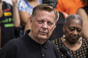 Father Michael Pfleger speaks during a news conference outside St. Sabina Church in Chicago.